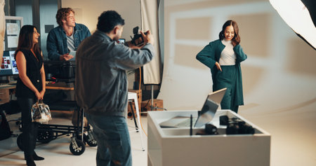 Photoshoot, studio and photographer with woman on set for creative, about us or career. Media, production and female model with photography behind the scenes for fashion magazine cover with agencyの写真素材