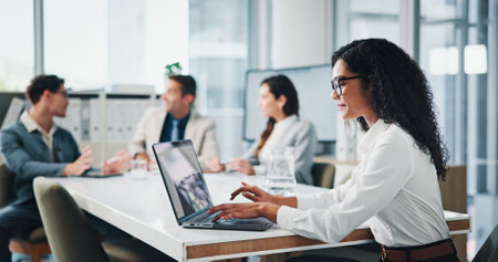 Meeting, colleagues and woman with laptop, boardroom and secretary with financial report on website. Business, people and receptionist with tech for notes, typing and info for investment in companyの写真素材