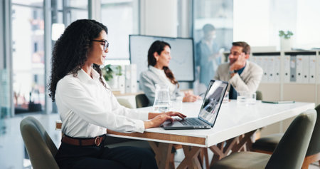 Meeting, businesswoman and typing with laptop in office, about us and research for stock market. Boardroom, female person and trader with tech for financial performance, risk management and corporateの写真素材