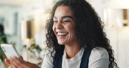 Phone, laughing and business woman in office for online message, funny chat and internet meme. Professional, creative worker and person on smartphone for social media, comic post and communicationの写真素材