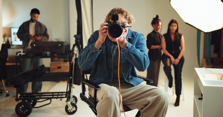 Camera, focus and photography with man in studio for photoshoot, preparation or shooting. Backstage, creative or media and photographer on set with makeup artist and model getting ready for filmの写真素材
