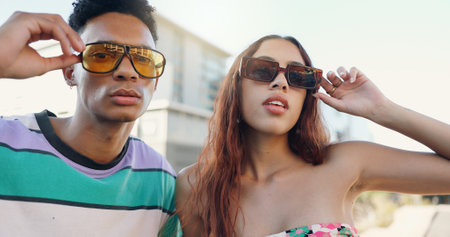 Sunglasses, cool or couple in city with fashion in summer for urban, edgy or trendy style together. Streetwear, gen z man and creative woman in town for youth culture, unique eyewear or modern swagの写真素材