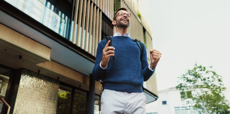 Commuting, excited and man with smartphone, street and celebration with tech for opportunity, travel or smile. Outdoor, happy and person with mobile for work, road and new job for employee or victoryの写真素材