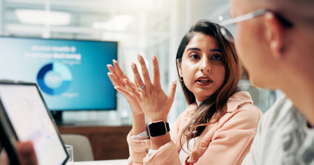 Business, people and talking in office for meeting discussion, team planning and ideas for finance growth. Staff, explain and tablet with marketing research, financial report and investment proposalの写真素材