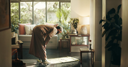Muslim, man and bow for praying at house of spiritual worship, praise Allah and belief in Ramadan. Male person, prayer or dua in salah, forgiveness and mindfulness of fasting tradition in Islam faithの写真素材