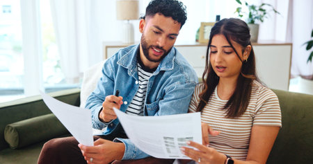 Documents, taxes and couple on sofa in home for bills, payment receipts and banking. Marriage,...