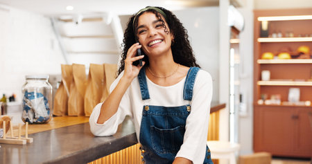 Phone call, smile and woman in cafe, talking and communication for date with tech, relax and retail. Laughing, customer and person with mobile for conversation, happy and break in coffee shop or chatの写真素材