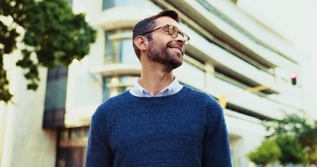 Thinking, creative man and smile in city for career planning, reflection and ideas for job opportunity. Male person, thoughts and morning commute with urban problem solving, legal solution and memoryの写真素材
