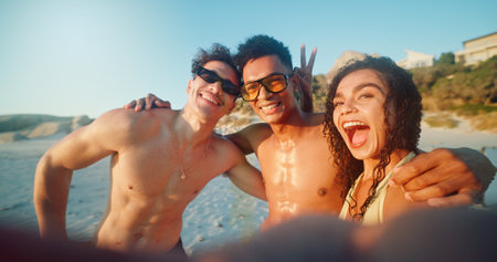 Beach, selfie and portrait of friends by ocean on vacation, adventure or holiday together for travel. Fun, happy and people by sea with photography picture on tropical weekend trip for memory.の写真素材
