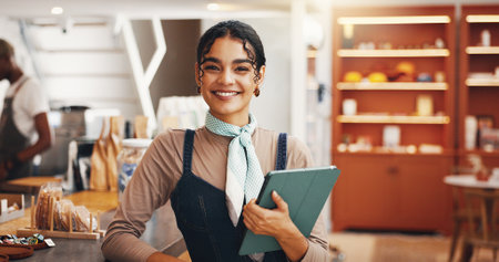 Tablet, smile and waitress with woman in cafe for inventory checklist, restaurant stock order and sales. Hospitality, store and menu planning with portrait of person in coffee shop with happy hostessの写真素材