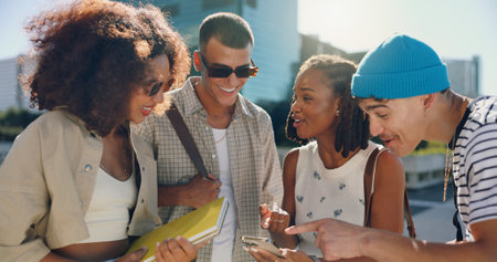 Smile, friends and talking with phone in city for social media, reading funny joke and group bonding. Happy, people and streetwear fashion with mobile, gossip news and streaming video of trip reunionの写真素材