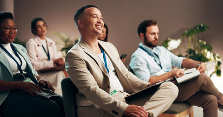Conference, office and audience of business man for presentation, seminar and convention. Professional workers, corporate and people listening with notes for meeting, training event and workshopの写真素材