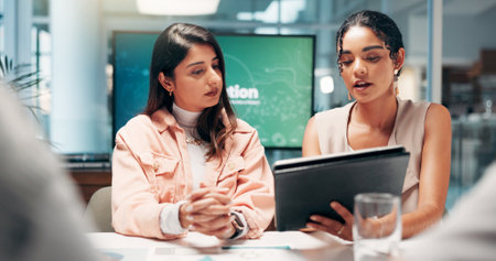 Discussion, teamwork and people with tablet, business and review of ad campaign performance and media manager. Serious, tech and digital marketing in office, website and collaboration in meetingの写真素材