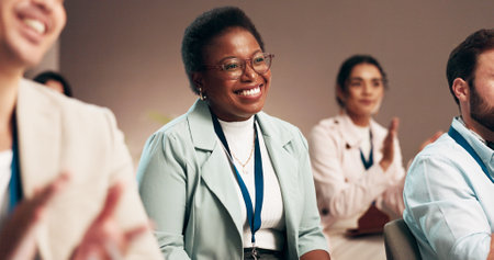 Happy, business woman and seminar with applause for presentation, speech or conference at office. Female person, employee or crowd clapping with smile for group talk, meeting or cheering in boardroomの写真素材
