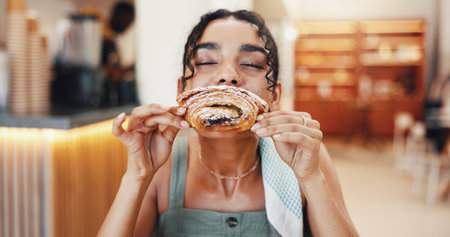 Cafe, happy and woman pastry eating for breakfast with snack, meal and hungry with craving. Coffee...