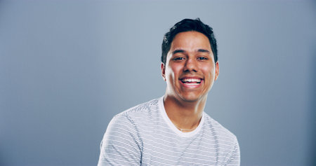 Space, laughing or portrait of Indian man in studio with confidence, mockup or humor. Comedian,...
