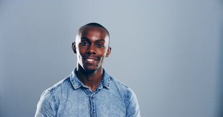 Space, designer or portrait of black man in studio with confidence, mockup or fashion. Entrepreneur, proud or face of happy male person isolated on grey background with denim shirt or creative careerの写真素材