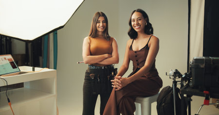 Portrait, production model and happy women on set for photoshoot, fashion magazine or style. Makeup artist, photography and people with smile for behind the scenes, creative catalog or art for mediaの写真素材