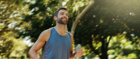 Smile, active man and earpods for running outdoor of cardio exercise, endurance training and marathon practice. Male athlete, runner and sports workout, fitness performance and listening to podcastの写真素材