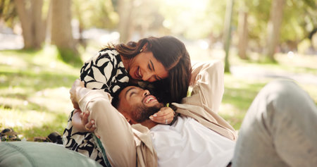 Laughing, bonding and couple on date, picnic and joke for conversation in nature, smile or...