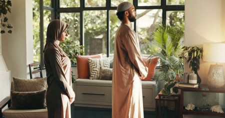 Muslim, couple and Islam praying at house of spiritual worship, religion respect and praise to Allah. People, marriage and fasting for Ramadan tradition, holy devotion and gratitude for belief in Godの写真素材