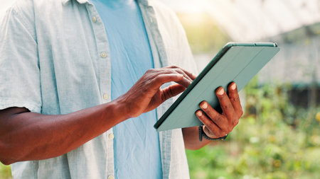 Greenhouse, farming and hands with tablet for research, plants information and app for harvesting tips. Closeup, person and farmer with digital for online inspection, sustainability and crops growthの写真素材