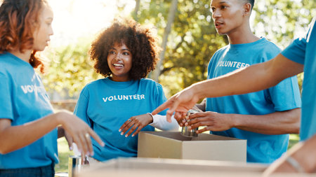 People, volunteer and boxes of donation at park for giving food, packing supplies and community aid. Staff, helping and sorting products for charity outreach, teamwork and distribution of NGO welfareの写真素材