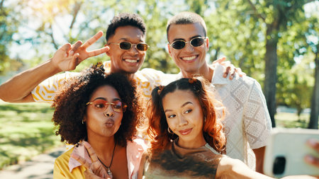 Selfie, happy people and friends in nature for photograph together for cool fashion, bonding or reunion. Hangout, social media influencer or men with women in park for picture, vacation or holidayの写真素材