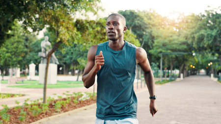 Running, fitness and black man in park for exercise, marathon training and workout on outdoor path....