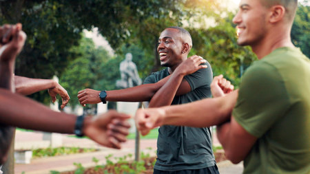 Fitness, stretching and men with smile, group or happy for exercise in morning, laughing or sport. Outdoor, team and people with routine for workout, warm up and healthy in nature, runner or togetherの写真素材