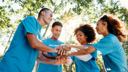 Volunteer, team or people stack hands for support, donation goal or cooperation in low angle...