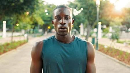 Fitness, tired and black man with portrait at park for workout recovery, running fatigue and training break. Athlete, serious and breathing in nature for exercise challenge, cardio rest and sweatingの写真素材