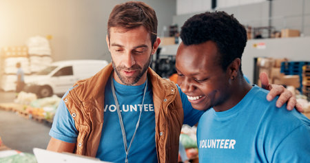 Men, volunteer and reading clipboard at warehouse for donation stock, inventory checklist and...
