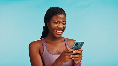 Phone, laughing and black woman in studio for networking, social media or texting on mobile app....