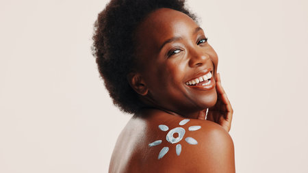 Sunscreen, cream and portrait with black woman in studio for beauty, uv protection and cosmetics. Space, dermatology and spf lotion with person on white background for self care, skincare or sunblockの写真素材