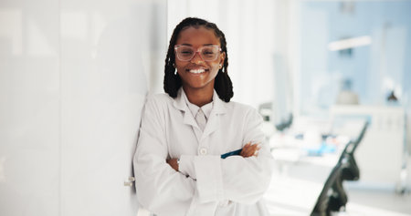 Portrait, science and black woman in lab, arms crossed and researcher with confidence. Face, African person and employee with pride, pathology and career ambition with female empowerment and biotechの写真素材