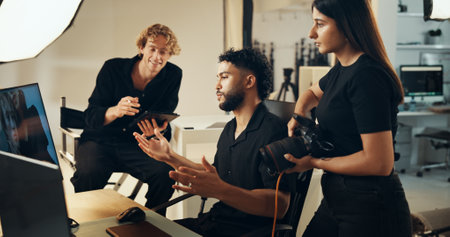People, backstage or planning for photography or teamwork for production results, talking or review. Staff, producer or computer to check for fashion photographer, magazine catalog or filming processの写真素材