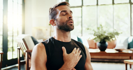 Yoga, man and breathe meditation in home, house or living room floor for energy, fitness or mental health. Relax, stress relief and zen person with mindfulness for pilates, spiritual healing or peaceの写真素材