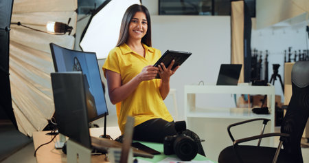 Photographer, tablet and woman with pictures, camera and happy for post production in studio or online. Photography, photo editor and person with tech for project, portrait and smile for magazineの写真素材
