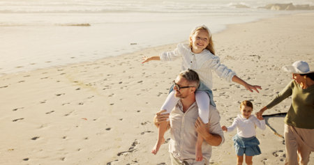 Kids, parents or walking at beach for space, holiday or travel in Australia with siblings, girls or family. Piggyback, mom or dad with children at sea space on vacation together for tourism, bondingの写真素材