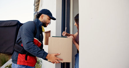 Delivery man, box and person at door of home for shipping, courier service and online shopping. Ecommerce, supply chain and customer with signature for package, parcel invoice and cargo receiptの写真素材