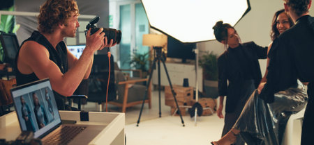 People, photographer and model with makeup for photoshoot, blog production and teamwork. Studio, group and shooting behind the scenes for fashion photography, magazine catalog and filming processの写真素材