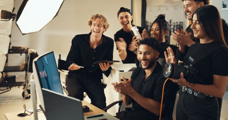 Fashion, people or clapping for photography success for production results, project or review. Team, producer or computer to check for studio photographers, magazine catalog or filming achievementの写真素材