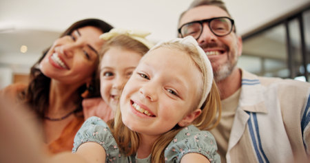 Selfie, smile and family on sofa in home for memory, bonding or social media post together. Goofy, photography and parents with girl children for silly profile picture in living room at house.の写真素材