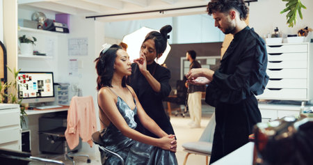 Accessories, photography or styling with makeup artist and model in studio for behind the scenes preparation. Getting ready, jewelry and woman on production set for catalog or magazine photoshootの写真素材
