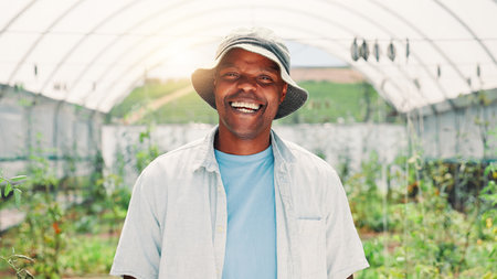 Happy, greenhouse and portrait of man on farm with plants for growth, sustainability and harvesting. Agriculture, nature and African farmer with agro business for healthy crops, vegetables or produceの写真素材