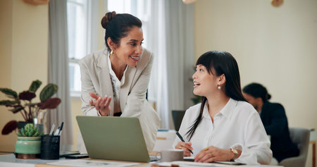 Business women, laptop and teamwork in office for advice, training and problem solving....
