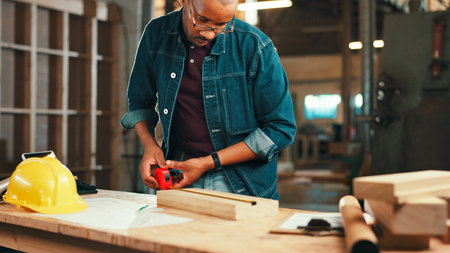 Measuring tape, carpenter and wood with planning for construction, furniture or project. Woodworker,...