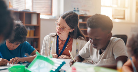 Write, education and teacher helping children in classroom for language development, learning or...