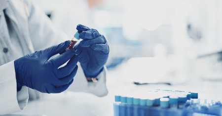 Person, hands and gloves with blood sample for DNA test, exam or medical discovery at laboratory. Closeup, scientist or research with vital fluid for clinic results, analysis or immunity cure at labの写真素材